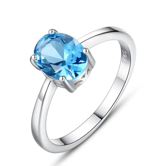 Anillo de plata de ley con topacio ovalado azul cielo natural y solitario
